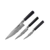 Drei Küchenmesser mit schwarzen Griffen und gemusterten silbernen Klingen, diagonal nach Größe auf Weiß angeordnet. Gefertigt aus 67-lagigem Damaststahl, ist dies das hochwertige Samura DAMASKUS 3er-Messer Set - schwarz von Samura.